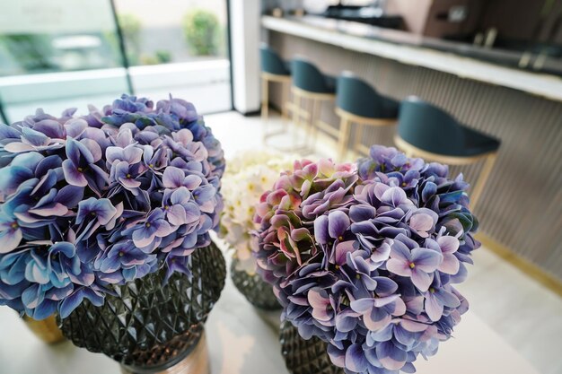 Home interior decor dried flowers in glass vase in Living room decoration rustic brown wooden table restaurant cafe interior