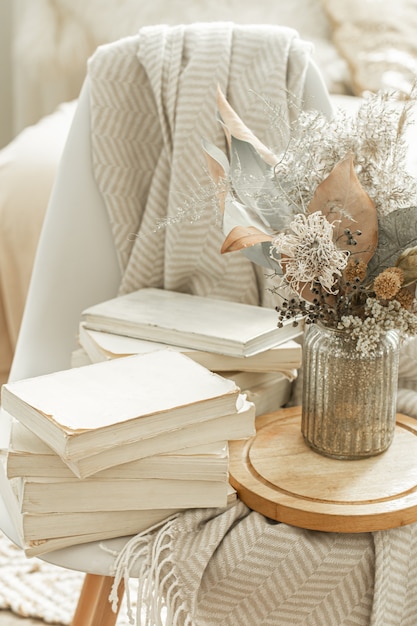 home interior with books and dried flowers.