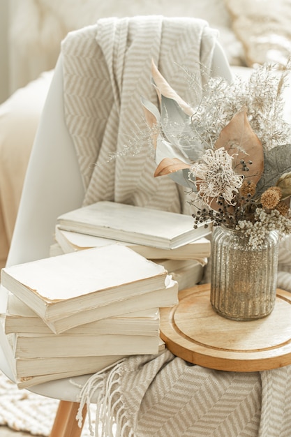 Home interior with books and dried flowers.