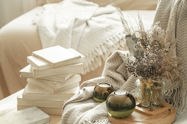 home interior with books and dried flowers.