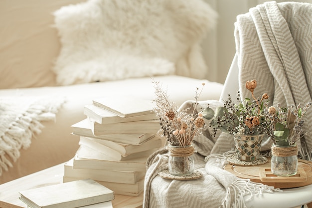 home interior with books and dried flowers.