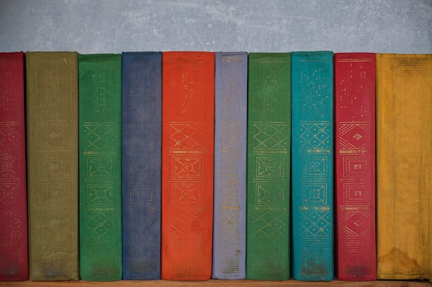 Home library of old battered retro books with colored spines