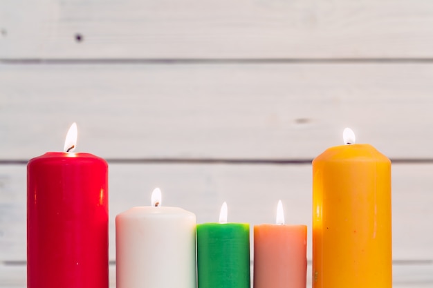 Home lighting candles on wooden table