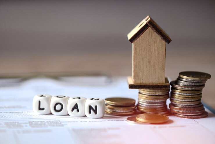 Photo home loan concept loan word on table with loan house model economy commercial real estate banks approve loans to buy homes business finance investments concept