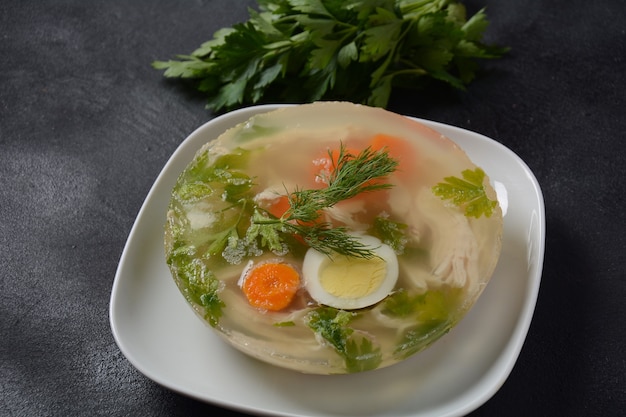 Home made aspic, jellied chicken meat with herbs and carrots. Traditional Russian dish holodets. Served with bread and mustard or/and horseradish