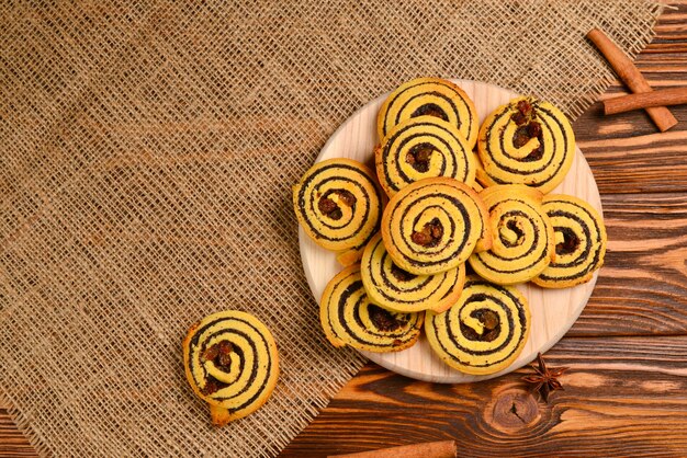 Photo home made baked cookies with raisins and poppy seeds. space for text or design.