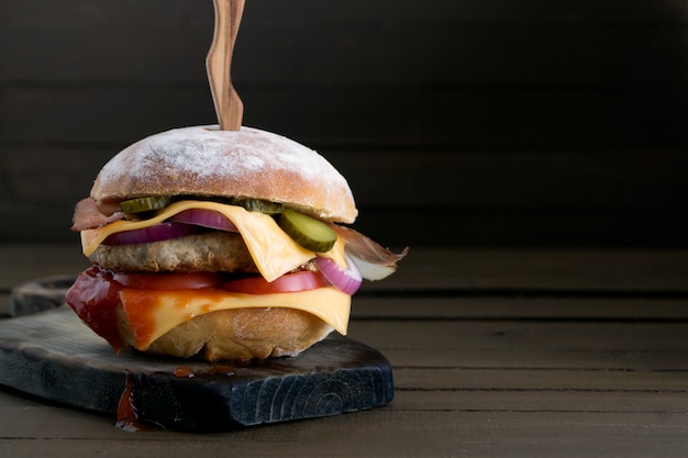 Photo home made big burger on wooden background.
