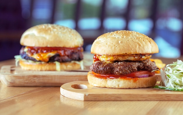 Home made burgers on wooden background