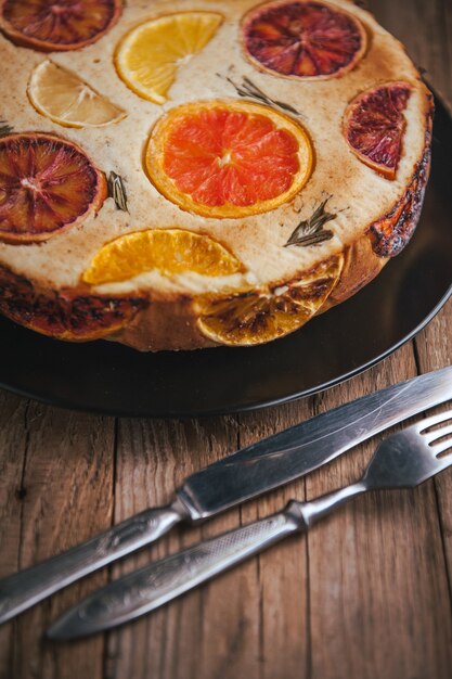 Home made citrus cake on wooden table in rustic style