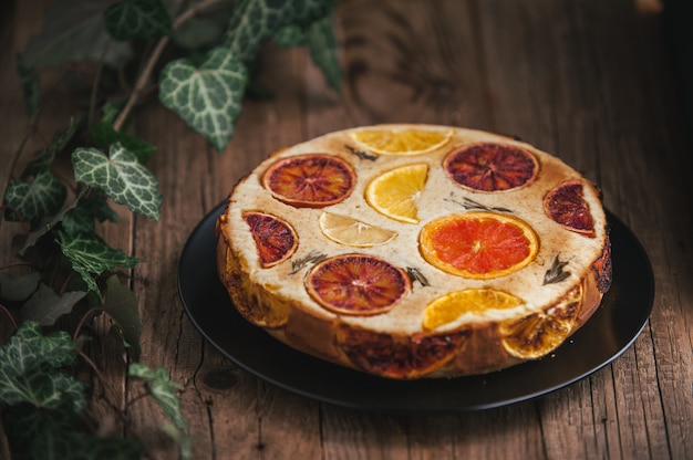 Home made citrus cake on wooden table in rustic style