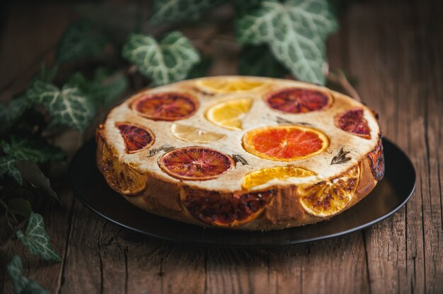 Home made citrus cake on wooden table in rustic style