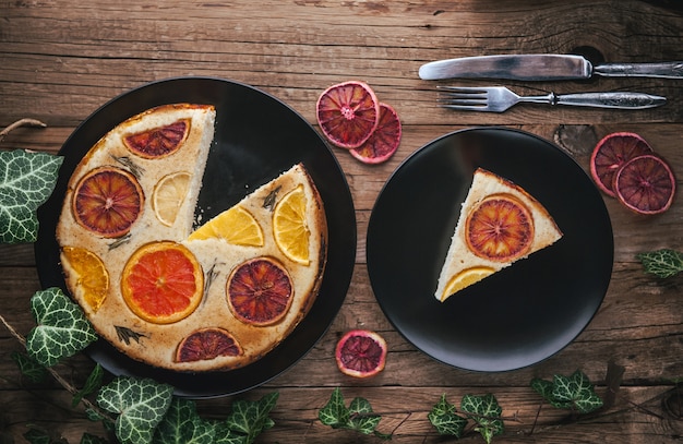 Home made citrus cake on wooden table in rustic style