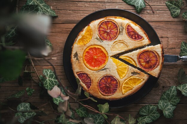 Home made citrus cake on wooden table in rustic style