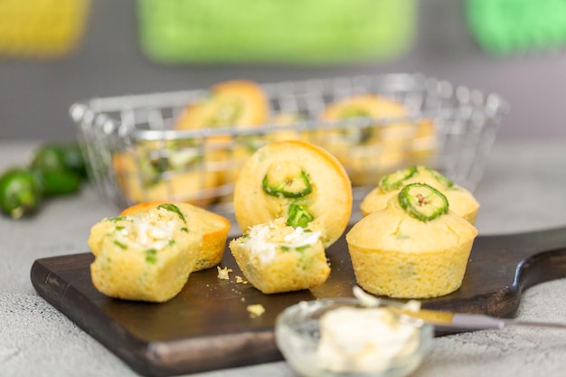 Home made cornbread muffins with spicy jalapeno pepper with butter spread.