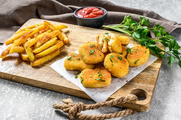 Photo home made fried chicken nuggets with french fries.