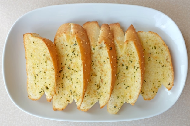 Home-made Garlic and herb bread slices on plate