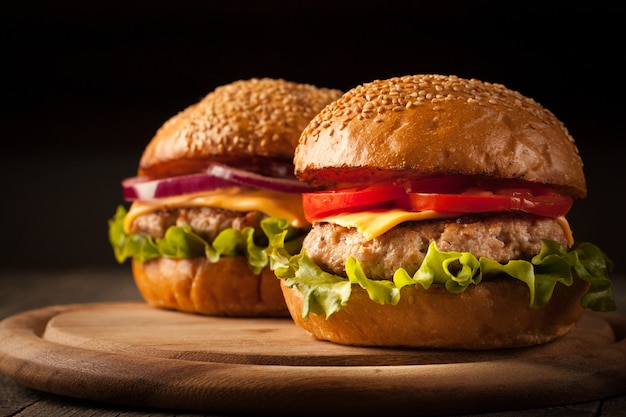 Home made hamburger with beef, onion, tomato, lettuce and cheese. Cheeseburger. 