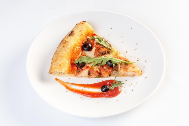 Home made pizza topped with black forest ham tomatoes spices black olives on white background