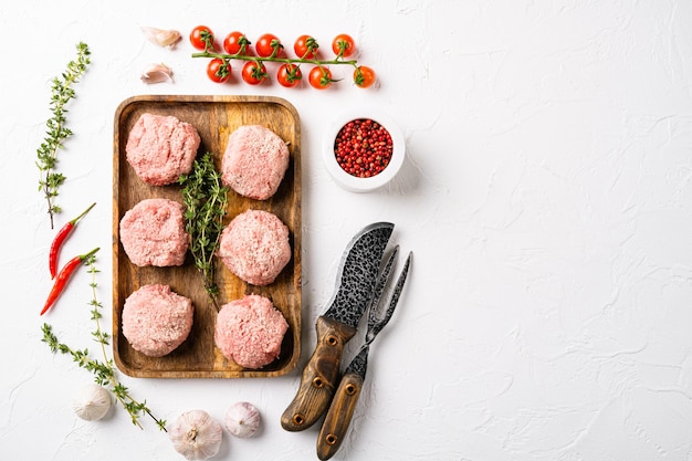 Home made raw meatballs set, on white stone table background, top view flat lay, with copy space for text