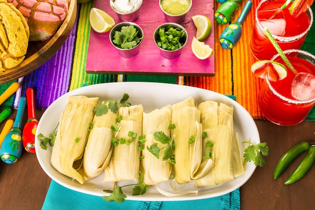 Home made tamales on serving plate on the party table.