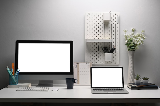 Home office desk, Two monitor Pc and Laptop computer on creative workspace with clipping path layer.