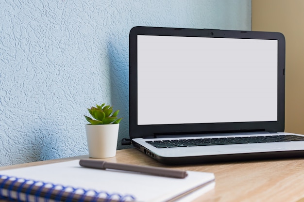 Home office. Open laptop with empty white screen. Business mockup.