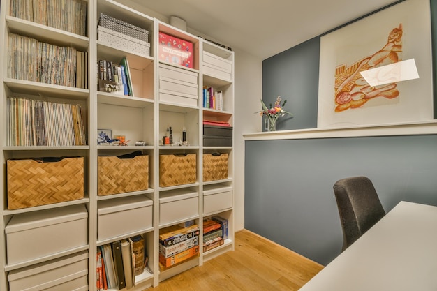 A home office with a large bookshelf filled