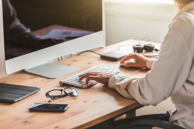 Home office, woman using computer to work from home