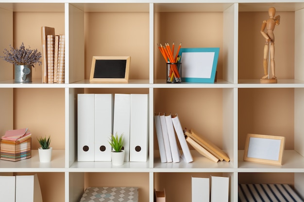 Photo home office working space. white shelf with accessories