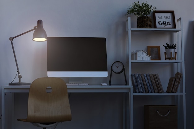 home office workplace at night, with focus on computer desk lit by dim lamp light