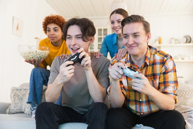 Home party cheerful group of friends playing video games at home happy diverse group buddies having