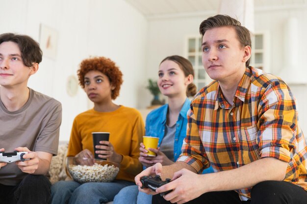 Home party cheerful group of friends playing video games at home happy diverse group buddies having