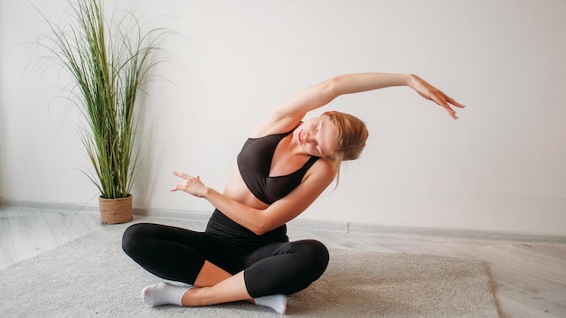 Home pilates yoga exercise woman stretching back