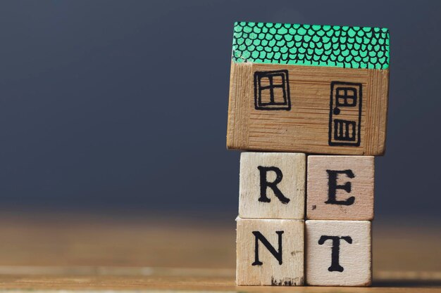 Home rent concept House model with rent word made from wooden blocks