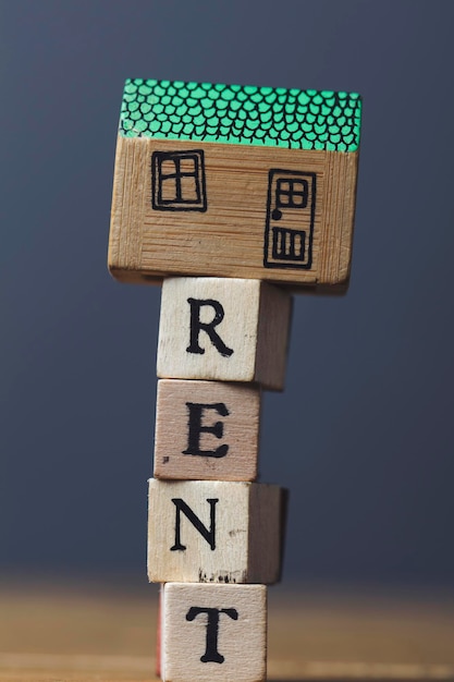 Home rent concept House model with rent word made from wooden blocks