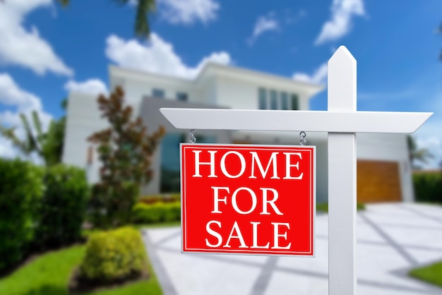home for sale real estate sign and beautiful new house