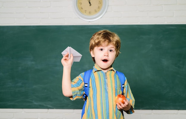 Home or school education small student boy painting in class origami lesson in school boy from