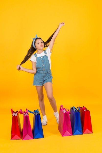 Home shopping happy childhood kid with package bags real shopaholic black friday sale special offer for you buy goods online during coronavirus lockdown small girl after successful shopping