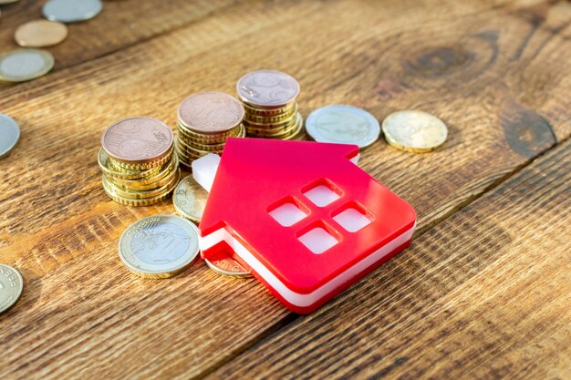 Home on the staked coins on wooden table