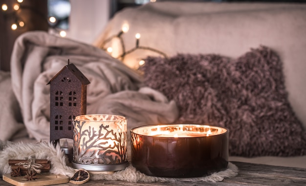 home still life in the interior with beautiful candles, on the wall of a cozy home decor