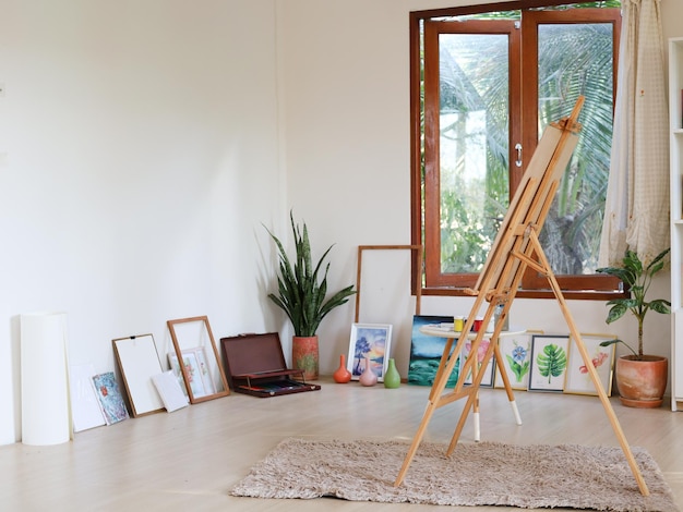 Home studio interior with artists workplace and foldable wooden easel