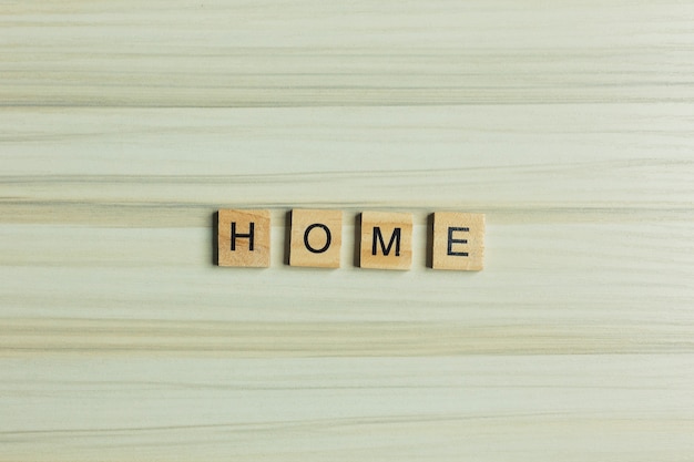 Home word on wood plate abstract background.