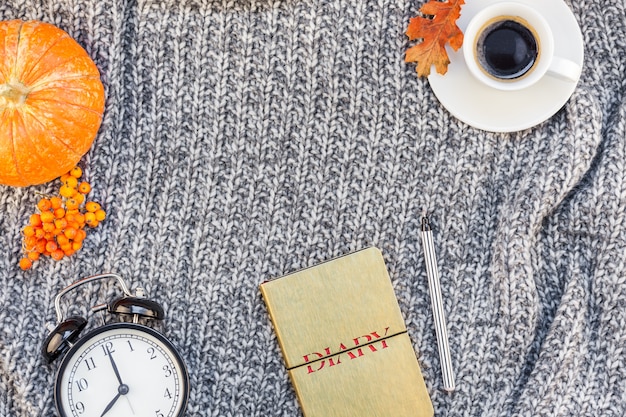 Home workplace with coffee cup on knitted plaid