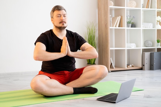 Home yoga meditating man online training harmony