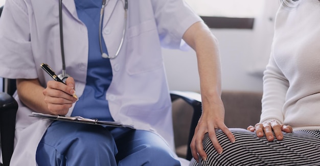 Homecare nursing service and elderly people cardiology healthcare Close up of young hispanic female doctor nurse check mature caucasian man patient heartbeat using stethoscope during visit