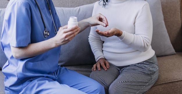 Homecare nursing service and elderly people cardiology healthcare Close up of young hispanic female doctor nurse check mature caucasian man patient heartbeat using stethoscope during visit