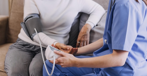 Homecare nursing service and elderly people cardiology healthcare Close up of young hispanic female doctor nurse check mature caucasian man patient heartbeat using stethoscope during visit