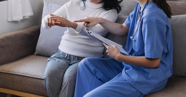 Homecare nursing service and elderly people cardiology healthcare Close up of young hispanic female doctor nurse check mature caucasian man patient heartbeat using stethoscope during visit