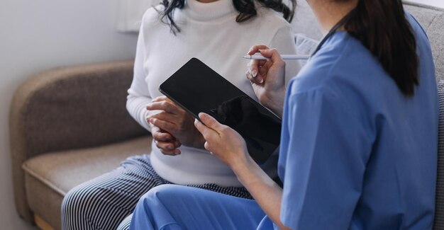 Homecare nursing service and elderly people cardiology healthcare Close up of young hispanic female doctor nurse check mature caucasian man patient heartbeat using stethoscope during visit