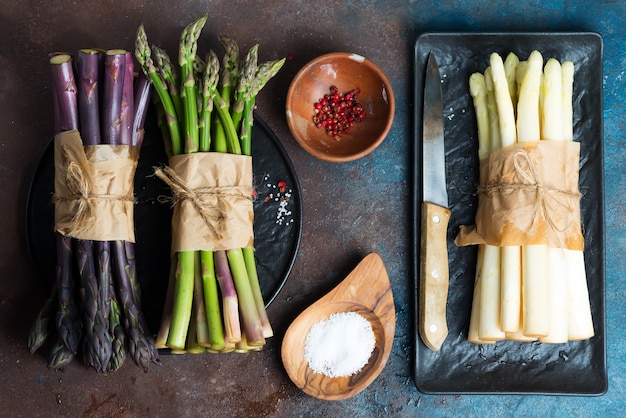 Homegrown fresh asparagus spears on a slate plate with spaces